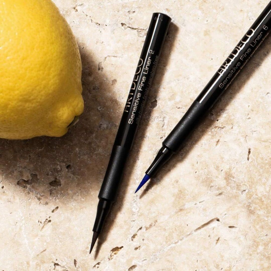 Assorted ARTDECO Sensitive Fine Liner liquid eyeliners in four colors, featuring sleek black packaging and fine tips for precise application.