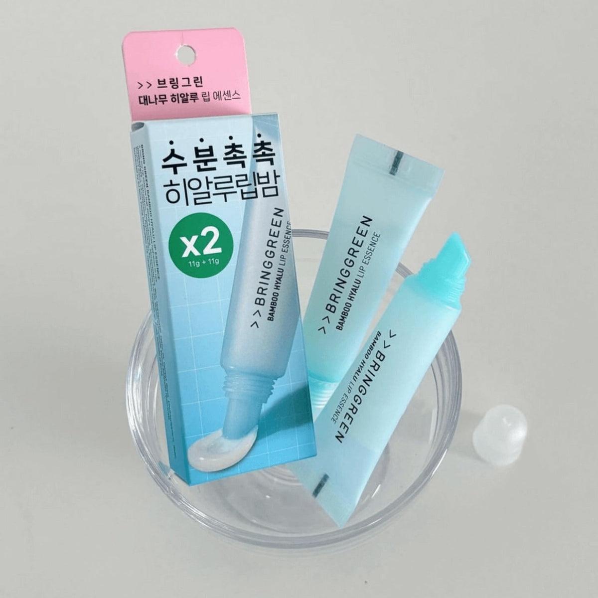 Bring Green Bamboo Hyalu Lip Essence Double Set featuring two lip balm and essence products with natural bamboo and hydrating hyaluronic acid.