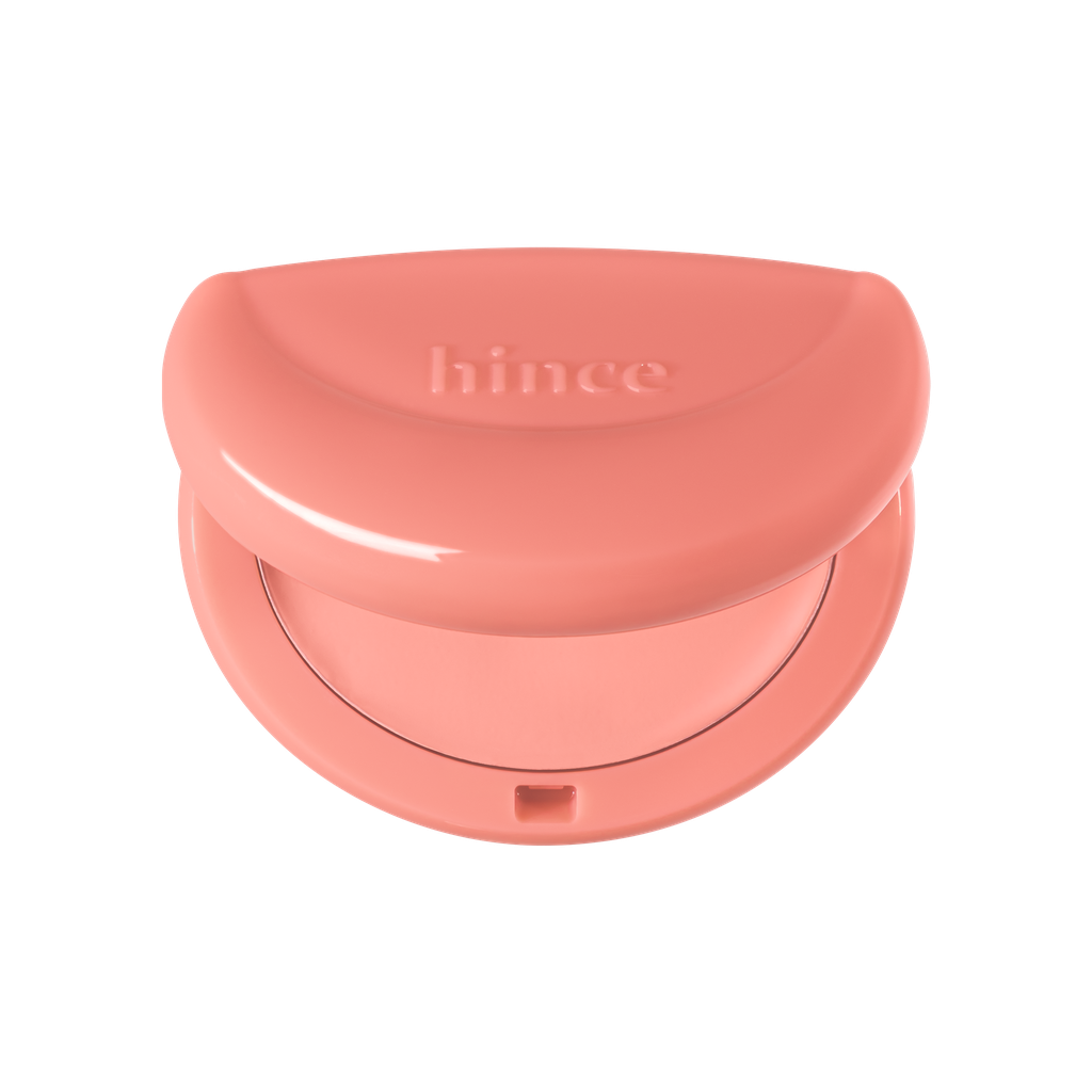 Hince Half-Moon Cheek Cream to Powder Blush in a sleek compact, showing the blush's soft pink shade and smooth texture.