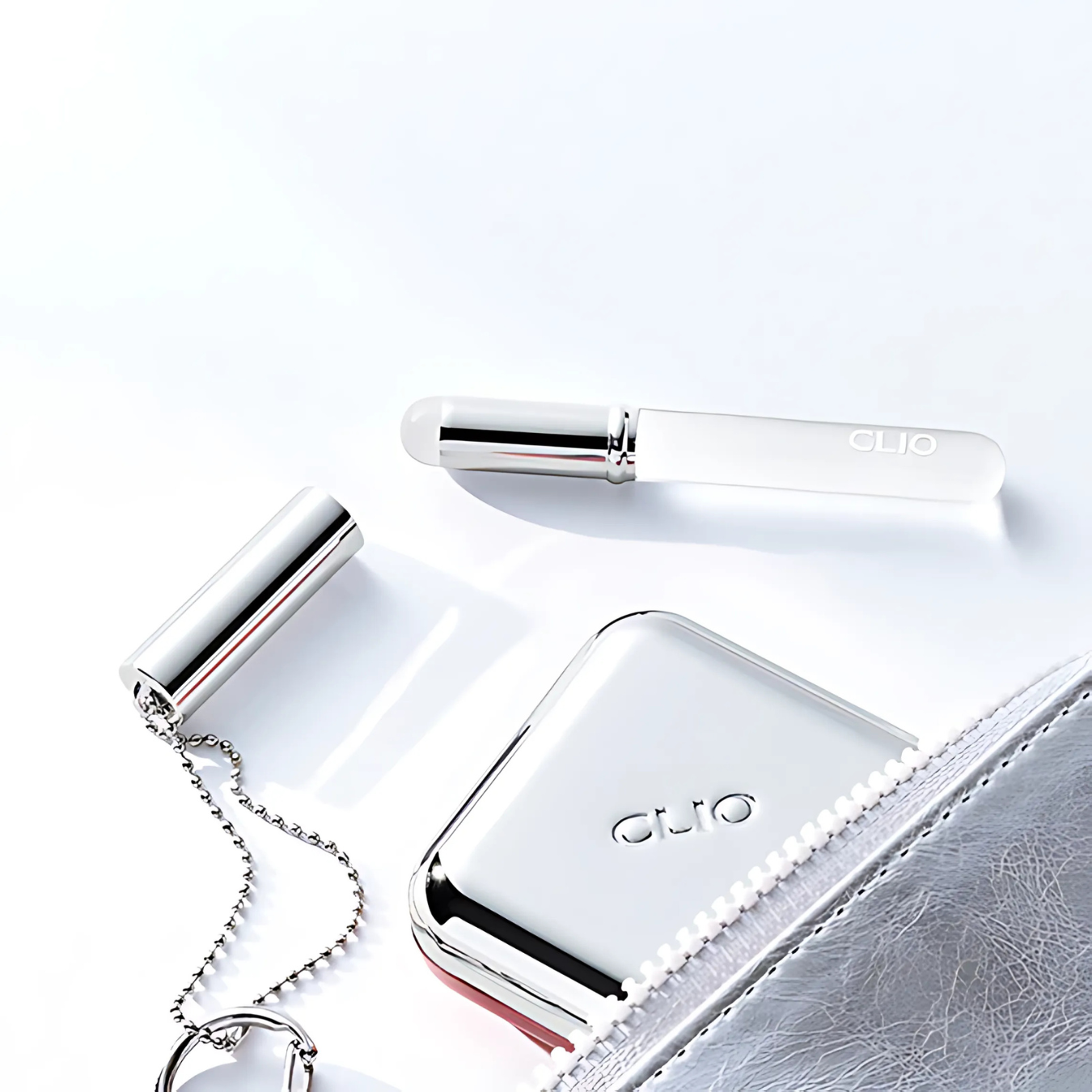 Clio Essential Lipcheek Tap blush with tap lip brush, portable compact for blush and lip color application.