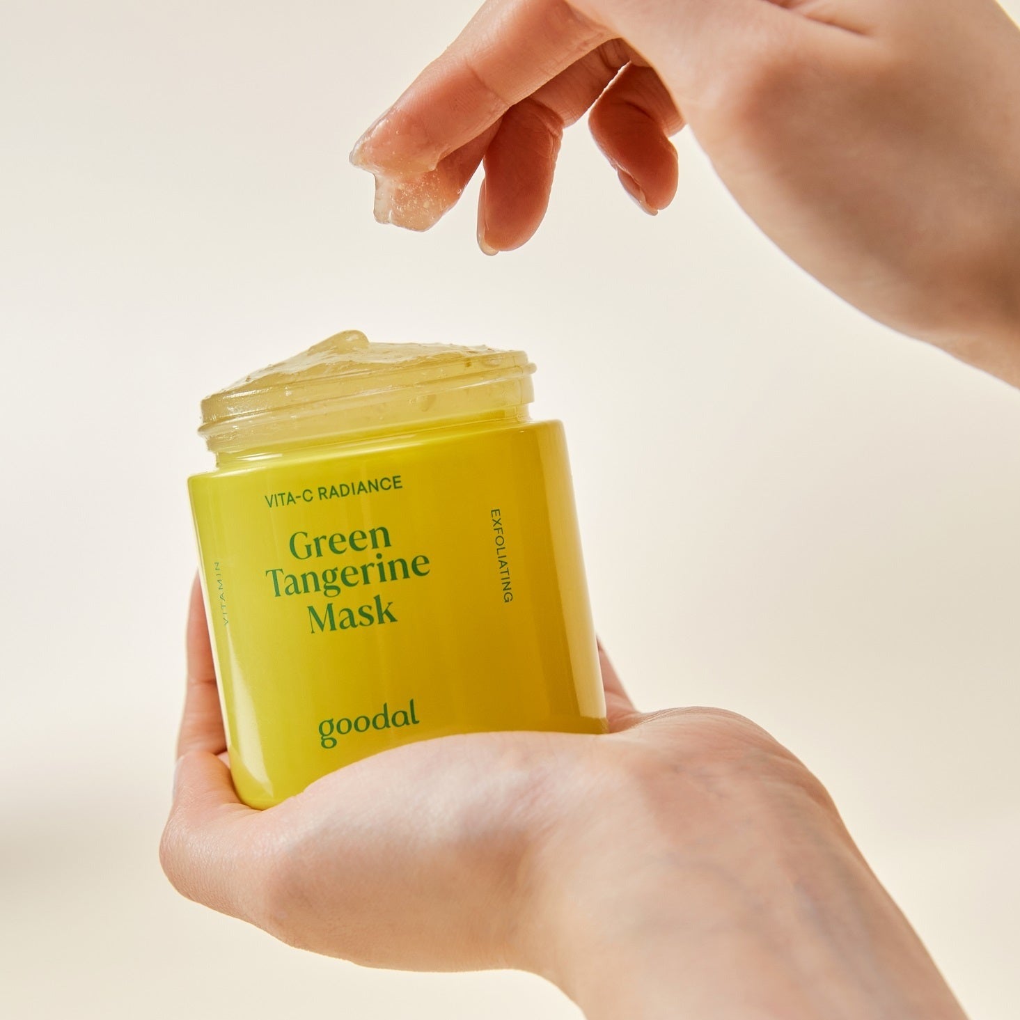 Green Tangerine Vita C wash-off mask by Goodal, with a vibrant orange-green product container and fresh citrus slices on a white background.