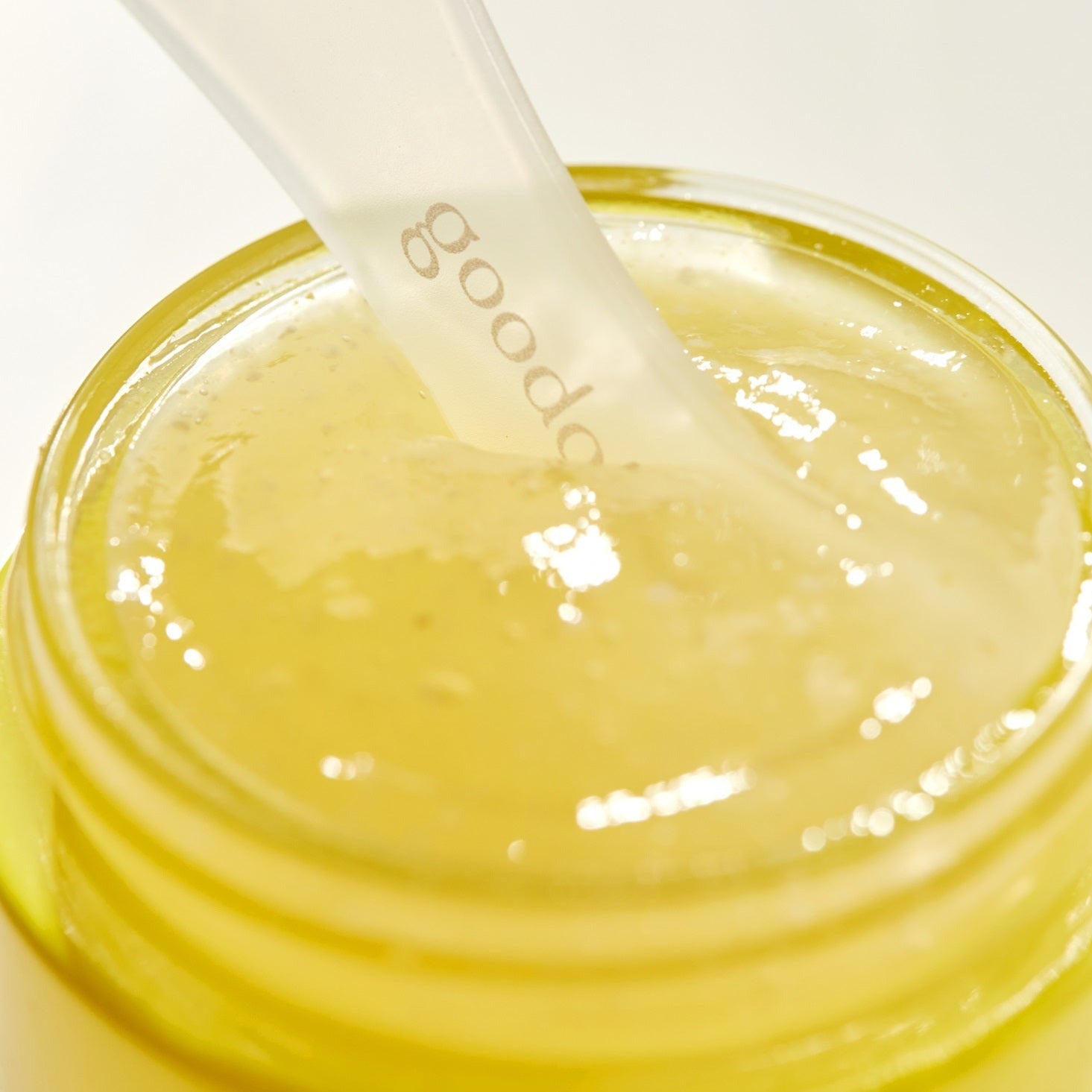 Goodal Green Tangerine Vita C Wash-Off Mask applied on skin, showcasing vibrant orange-green color and smooth texture.