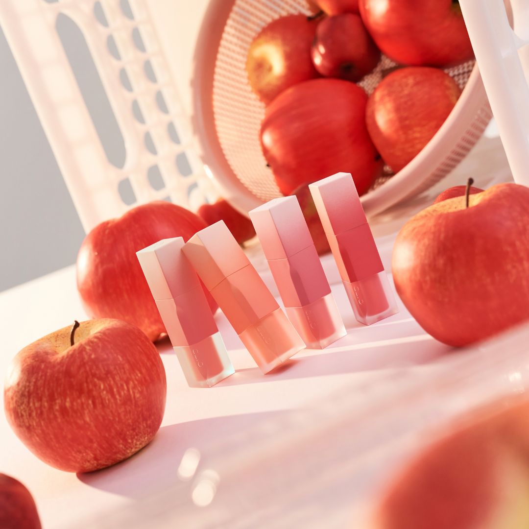 Clio Chiffon Blur Tint lip tint in four vibrant fruit-inspired shades, displayed in a close-up on a white background.