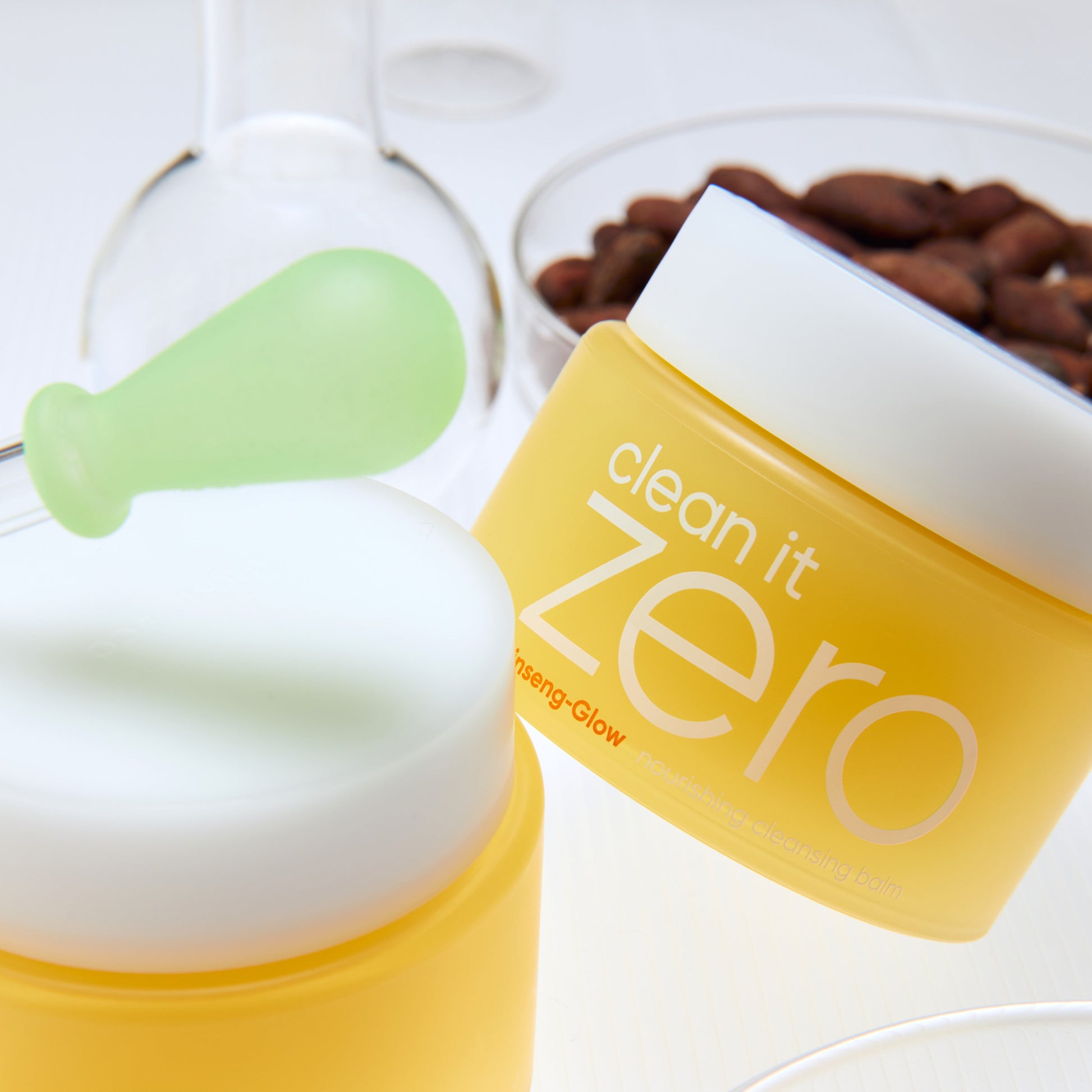 Banila Co Clean It Zero Nourishing Cleansing Balm 100ml jar with white lid and product label, surrounded by soft background.