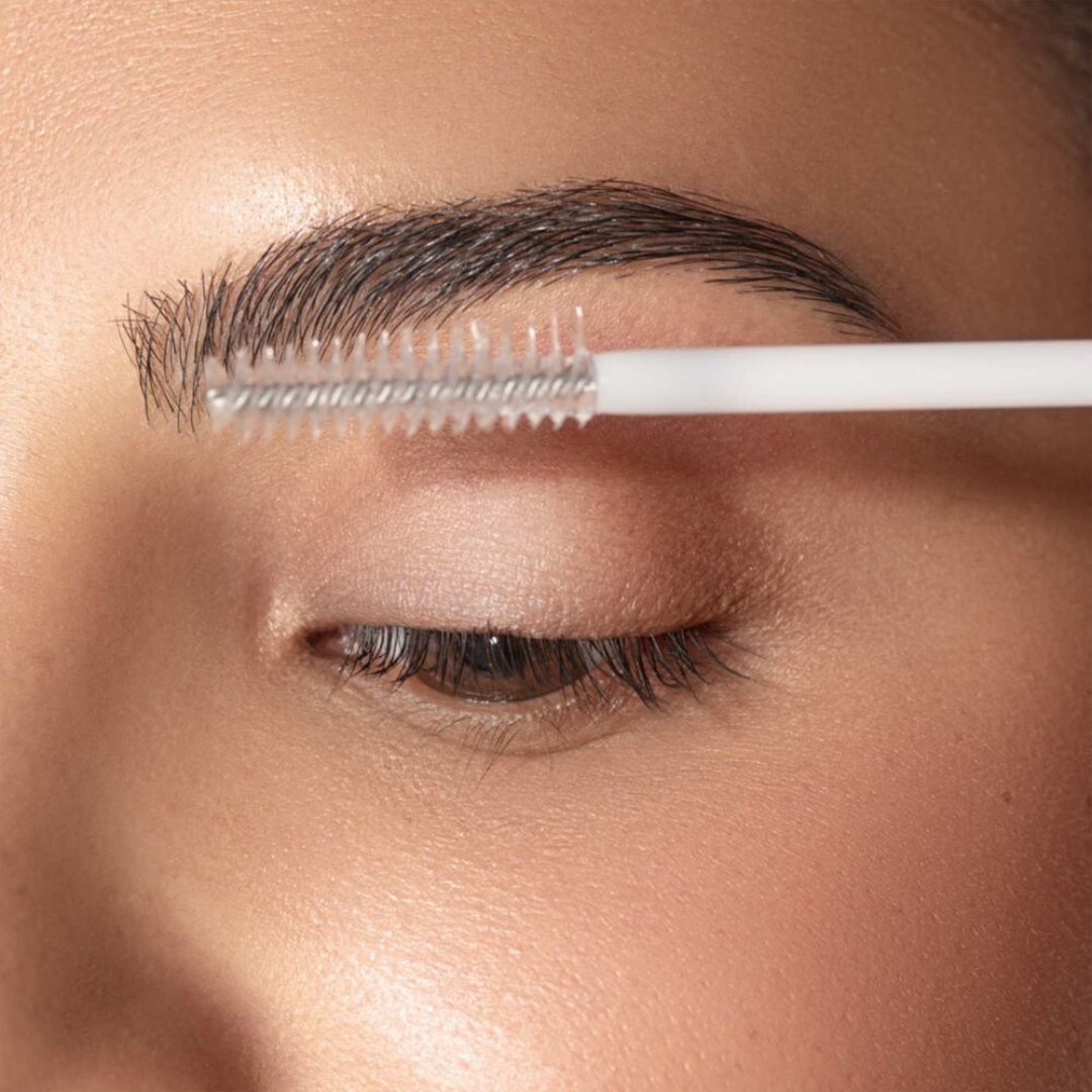 ARTDECO clear lash and brow gel in a transparent tube, designed to shape and set eyebrows and eyelashes.