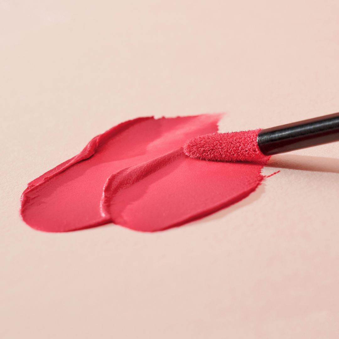Clio Chiffon Blur Tint lip tint in four vibrant fruit-inspired shades with a smooth, textured finish.