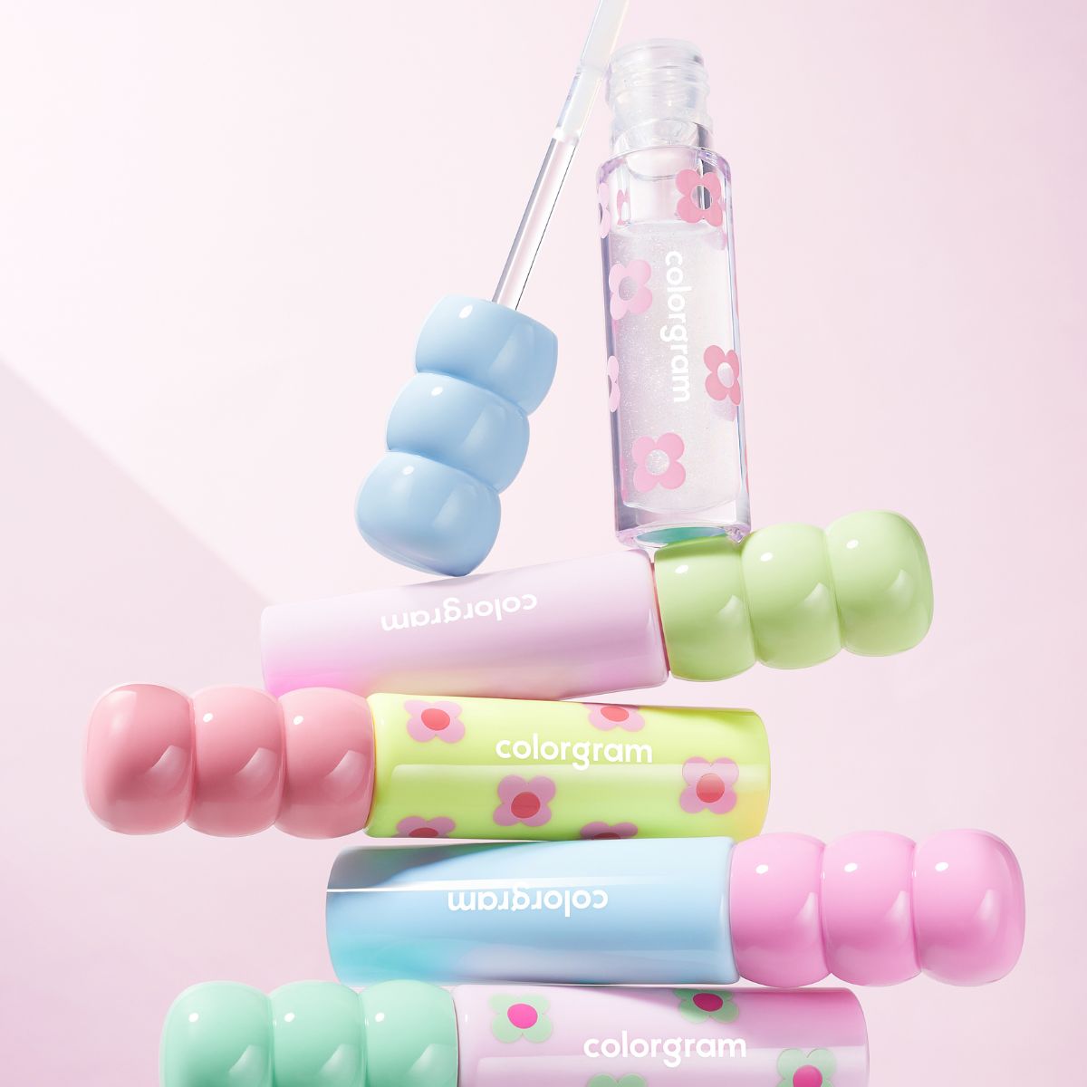 Colorgram Fruity Glass Lip Tint in vibrant shades, featuring a sleek applicator and glossy finish on a clear glass container.