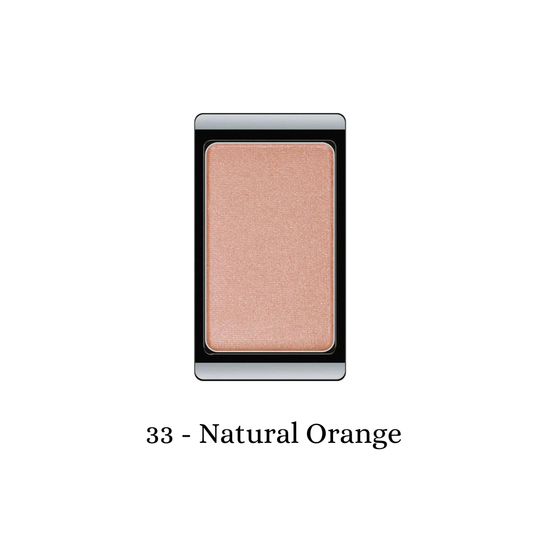 ARTDECO eyeshadow pearl in natural orange with a shimmering finish, showcased in a close-up image highlighting its smooth texture.