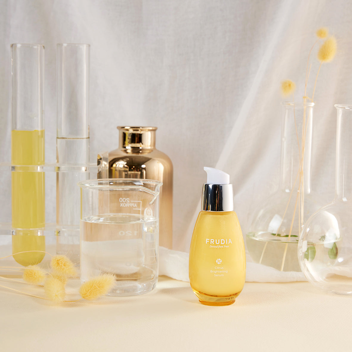Frudia Citrus Brightening Serum 50g bottle with orange label and dropper applicator, placed on a white background.