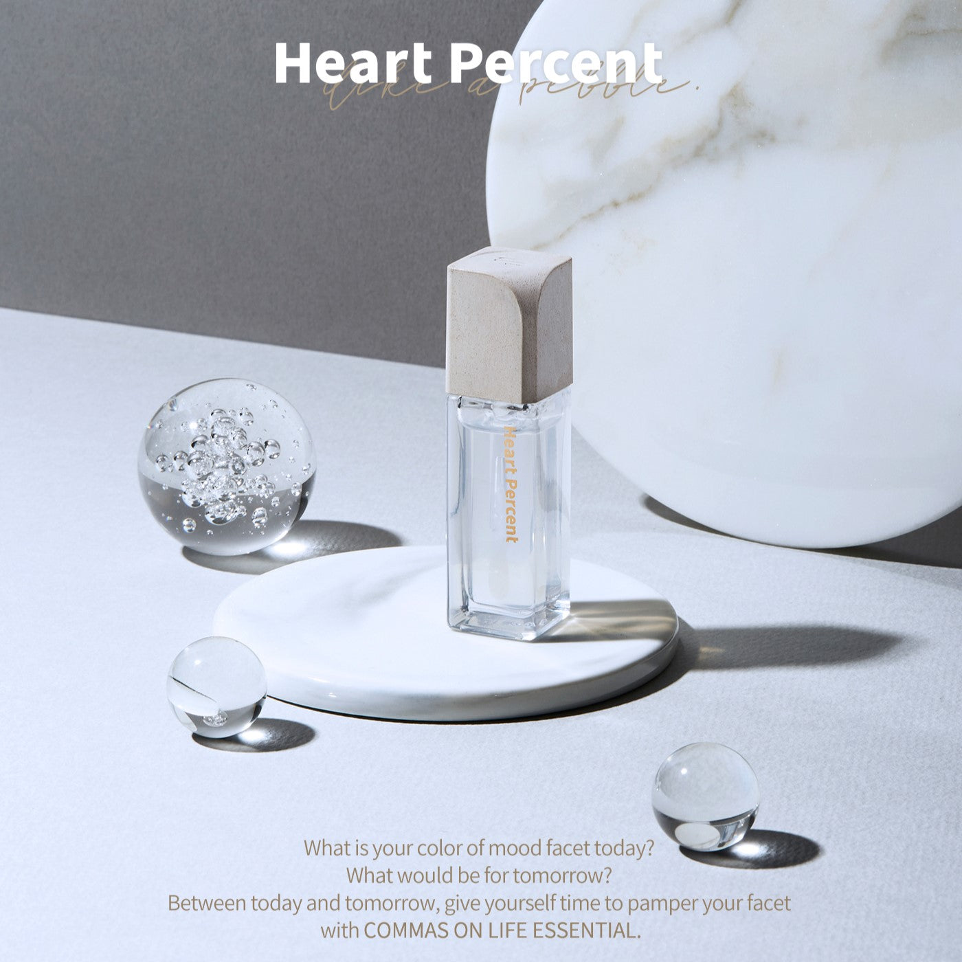 Heart Percent Commas on Life Essential Lip Essence 4.5ml lip gloss tube with clear packaging and branding visible.