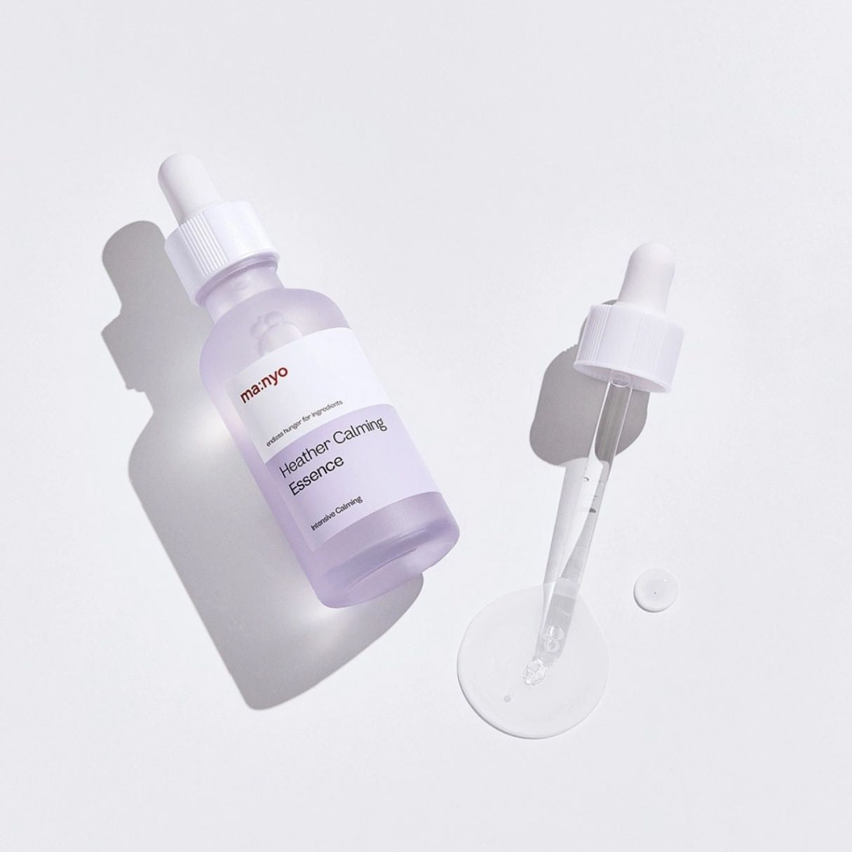 Ma:nyo Heather Calming Essence 50ml in a clear bottle, featuring a calming, herbal-infused essence for soothing skincare.