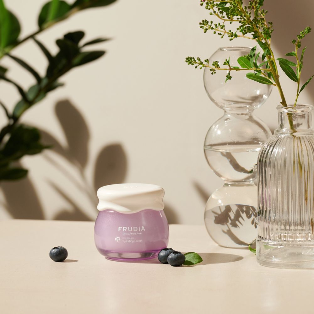 Frudia Blueberry Hydrating Face Moisturiser in 55g jar with blue packaging and creamy texture.