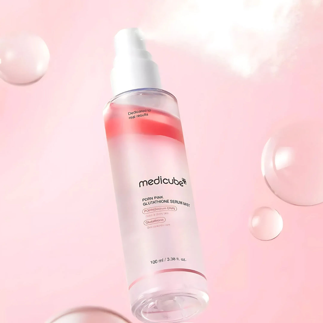 Medicube PDRN Pink Glutathione Serum Mist 100ml in a clear spray bottle, featuring a pink label and mist nozzle for facial skincare.
