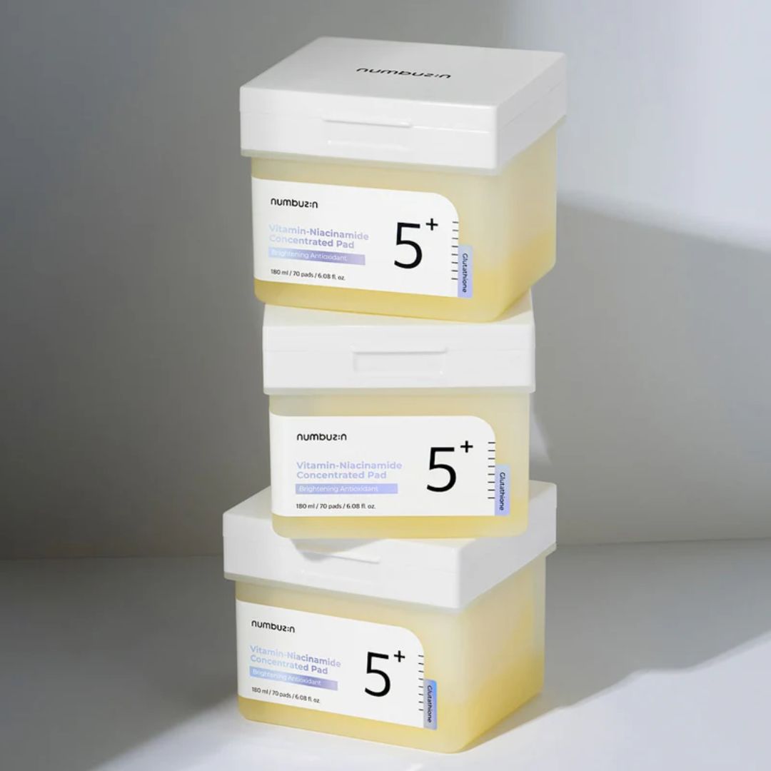Numbuzin No. 5 Vitamin-Niacinamide Concentrated Toner Pads, 70pcs, in a white container with open lid showing cotton pads inside.
