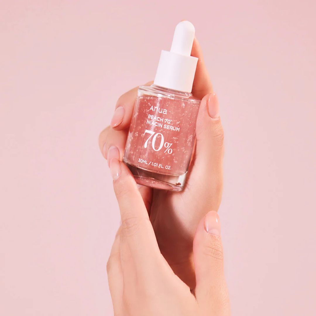 Anua Peach 70 Niacinamide Serum 30ml bottle, featuring a clear glass container with a white pump dispenser and peach-colored label