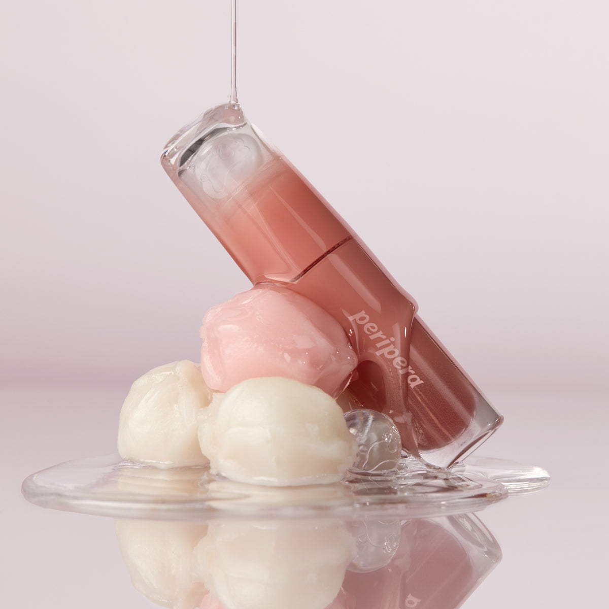 Peripera Ink Mood Glowy Tint in Tteok Recipe, a vibrant lip tint with a glossy finish, shown in a concept photo.