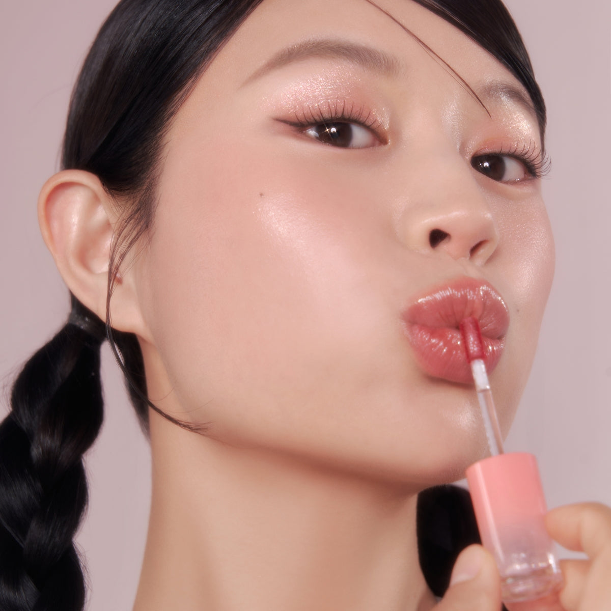 Peripera Ink Mood Glowy Tint in Tteok Recipe, a vibrant lip tint with a glossy finish, shown on a model's lips.