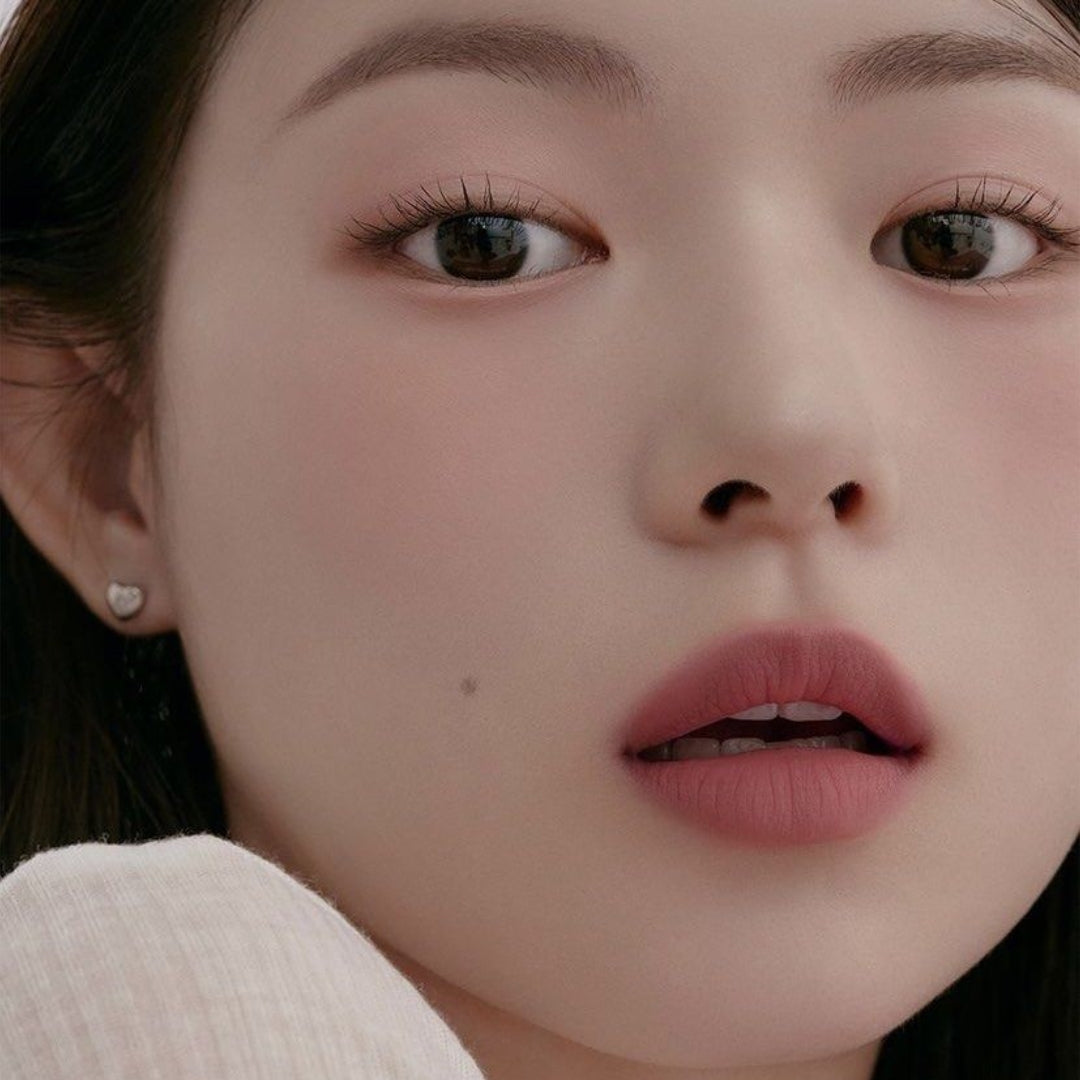 Peripera Slip On My Lip lipstick in a sleek tube with a vibrant pink shade, showcasing the product's smooth, glossy finish.