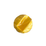 Yellow silicone mist holder accessory by d'Alba, showing a flexible, vibrant yellow container with a mist spray top.