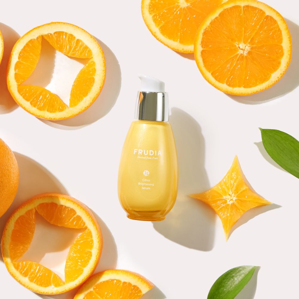 Frudia Citrus Brightening Serum in a clear 50g bottle with a pump dispenser, displaying fresh citrus fruits on the packaging.