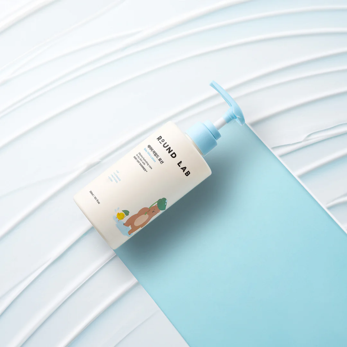 Round Lab Baby Mild Lotion 300ml, gentle body lotion for babies in a white and blue bottle with a pump dispenser.