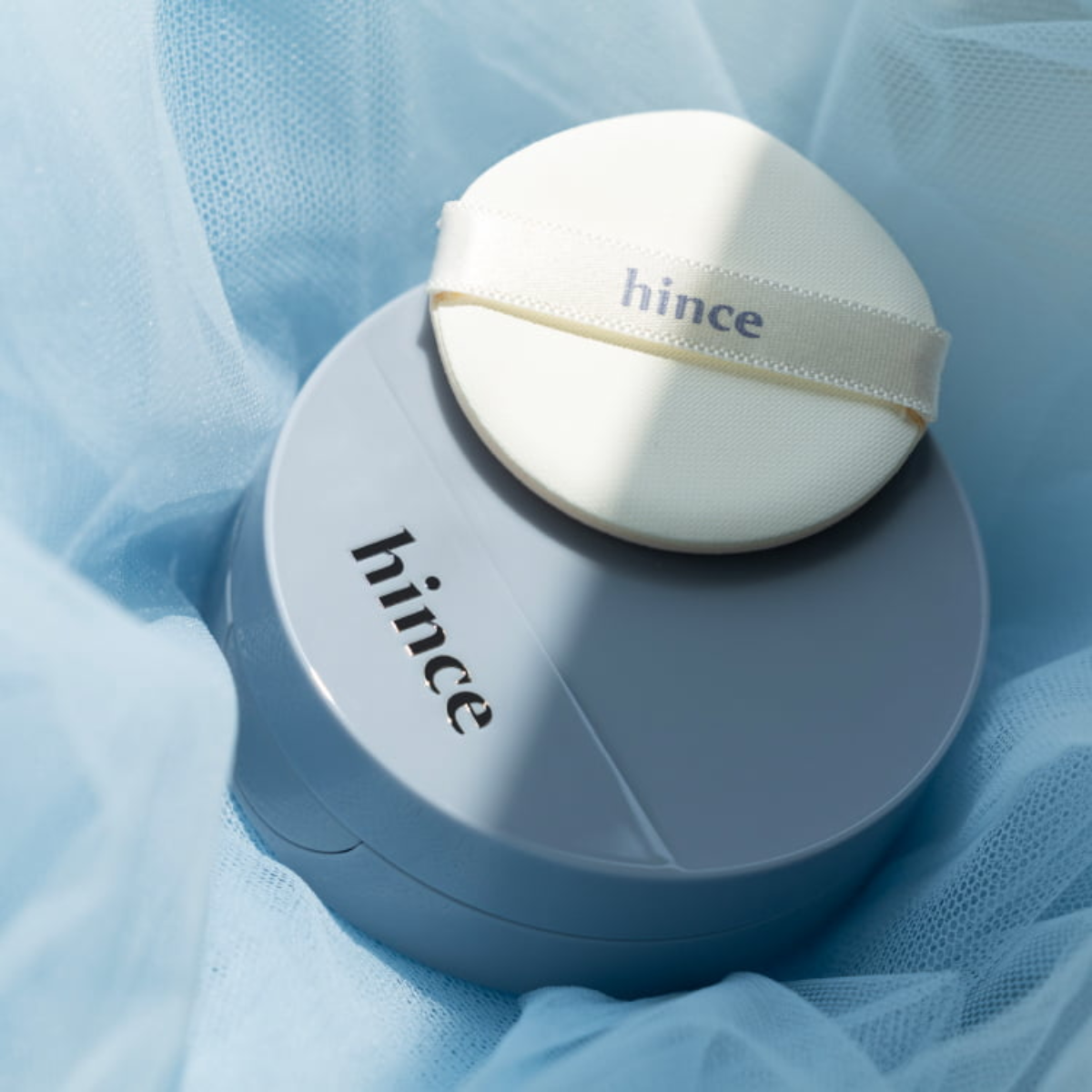 Hince Second Skin Mesh Matte Cushion foundation in a square compact with a sleek design and applicator puff inside.