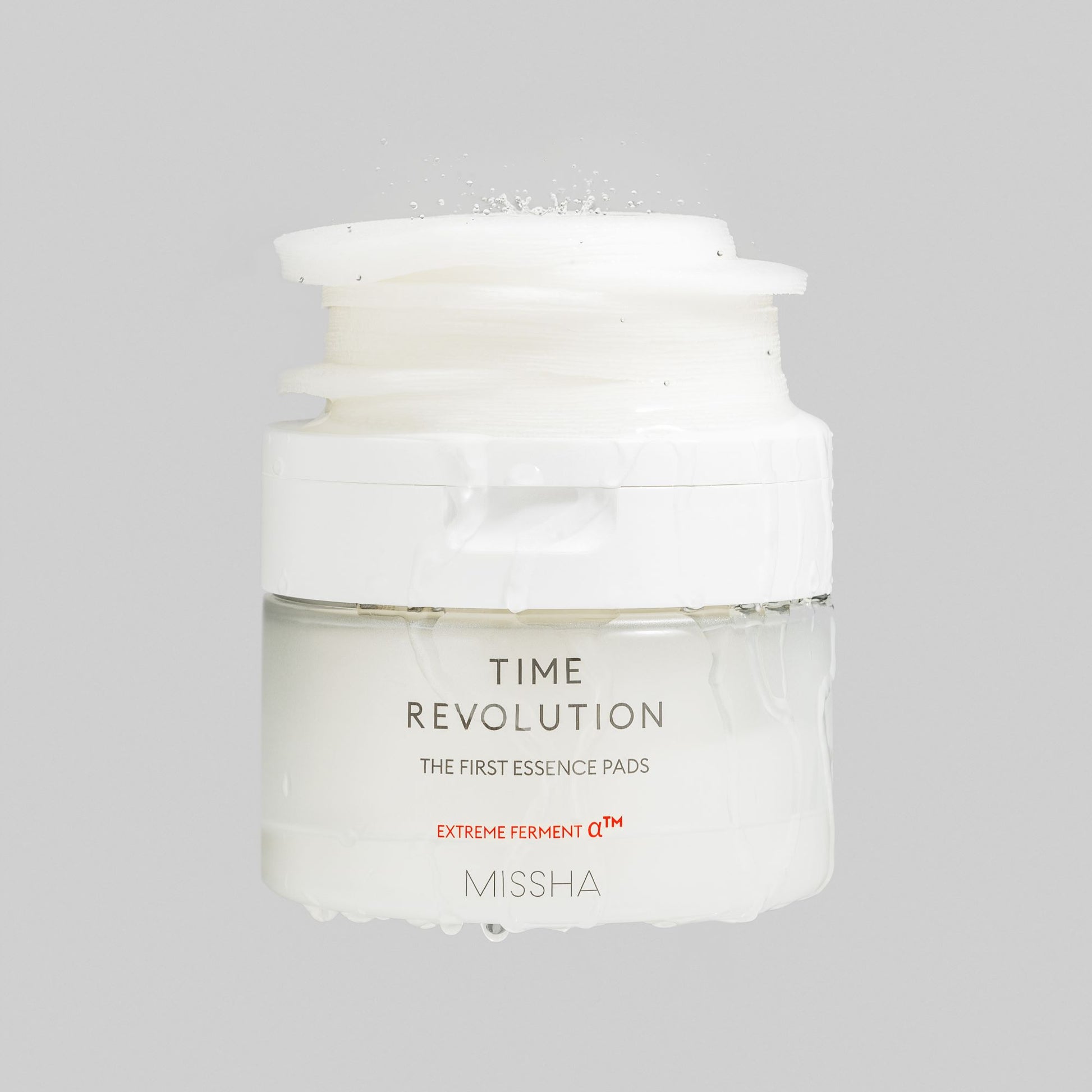 Missha Time Revolution The First Essence Toner Pads, 75-piece set, showing individual toner pads with branded packaging.