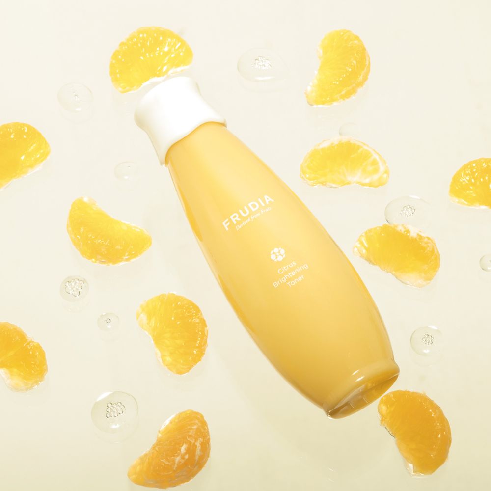 Frudia Citrus Brightening Toner 195ml bottle with clear liquid and citrus fruit imagery on the label.