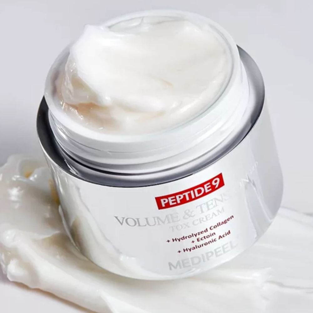 MEDIPEEL+ Peptide 9 Volume and Tension Tox Cream Pro face moisturizer, showcasing a sleek jar with creamy texture and elegant packaging.