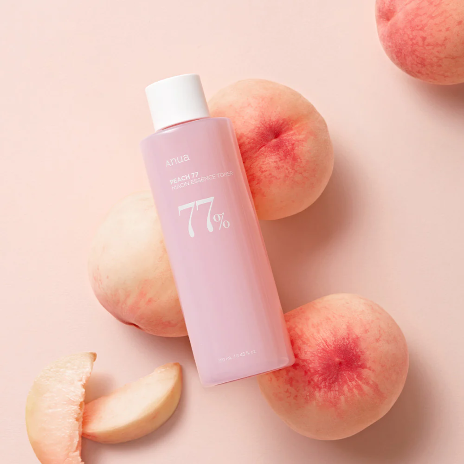 Anua Peach 77 Niacin Essence Toner in a 250ml bottle, featuring peach-colored liquid and clear packaging with a white cap.