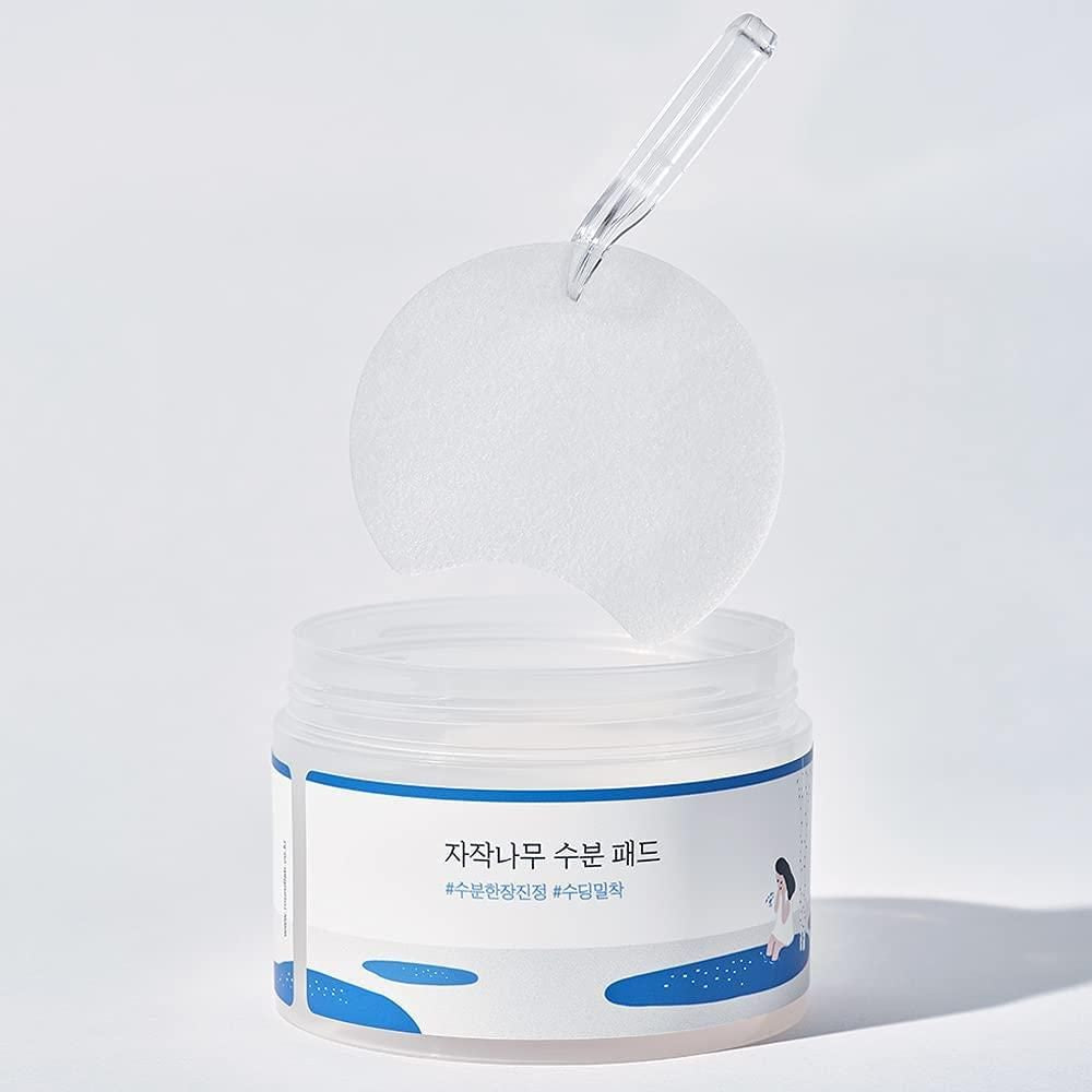 Round Lab Birch Juice Moisturizing Toner Pad with white bubbling texture in a white container, 80 pcs.