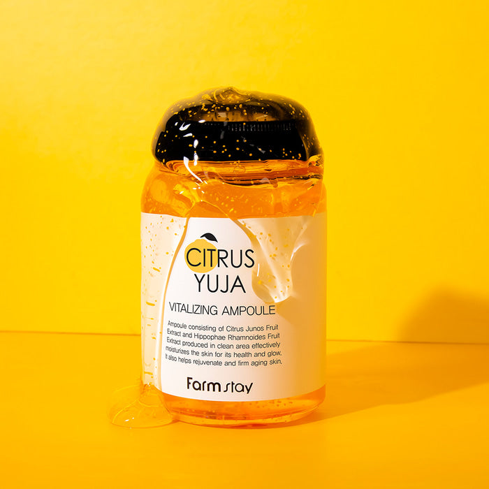 Farmstay Citrus Yuja Vitalizing Ampoule 250ml bottle with vibrant citrus fruit and clear liquid inside.