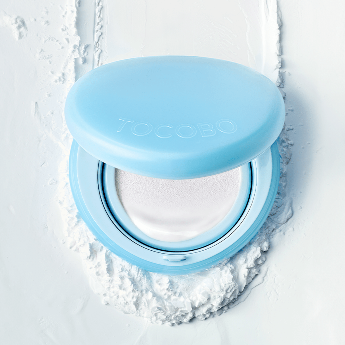 TOCOBO Blur Finish Mini Sun Cushion, compact sunscreen with a smooth finish, in a light-colored case with a cushion applicator.