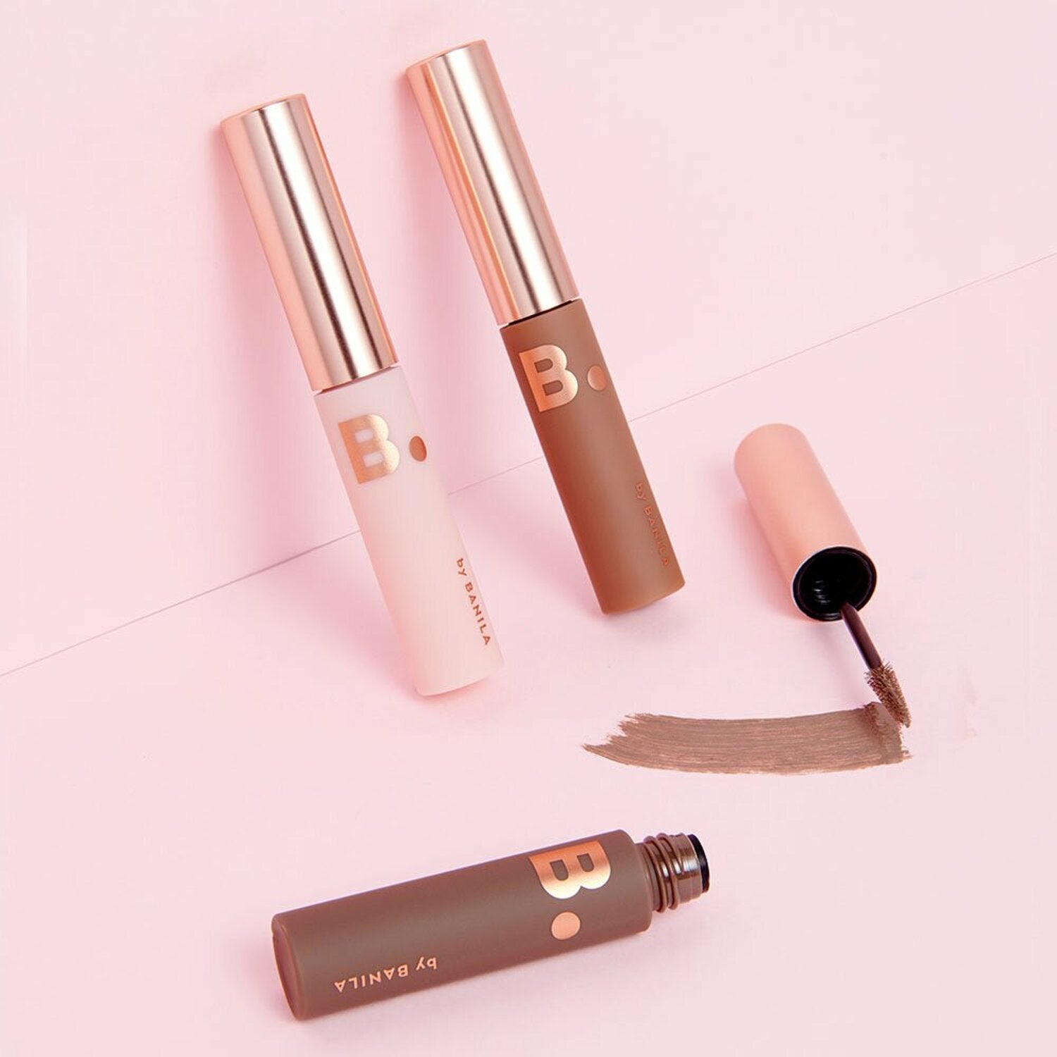 Banila Co B. By Banila Smudge Out Detail Browcara showing a brow mascara wand and product in a compact container.