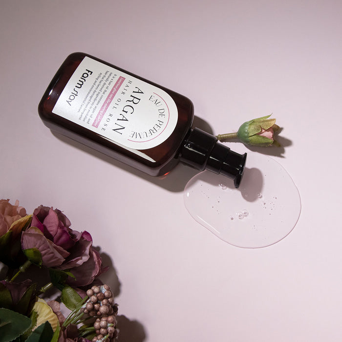 Farmstay Argan Hair Oil Rose Eau De Perfume bottle, 100ml, a luxurious conditioner and treatment for silky, fragrant hair.