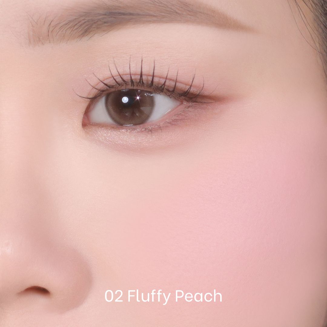 Peripera Pure Blushed Custom Cheek blush in soft peach shade, showing the smooth, pigmented powder in a compact with a mirror.