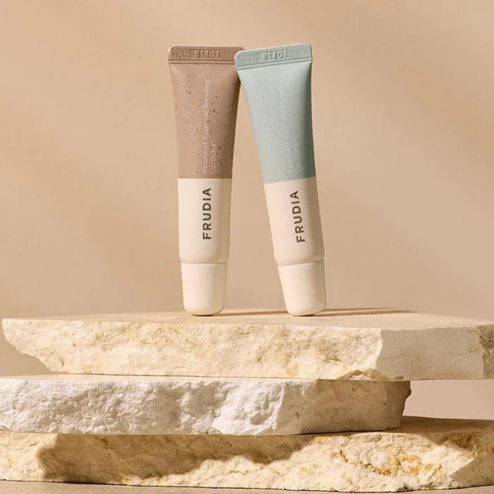 Frudia Re:proust Essential Blending Lip Butter Earthy 10g, green packaging with balm texture visible in a natural setting.