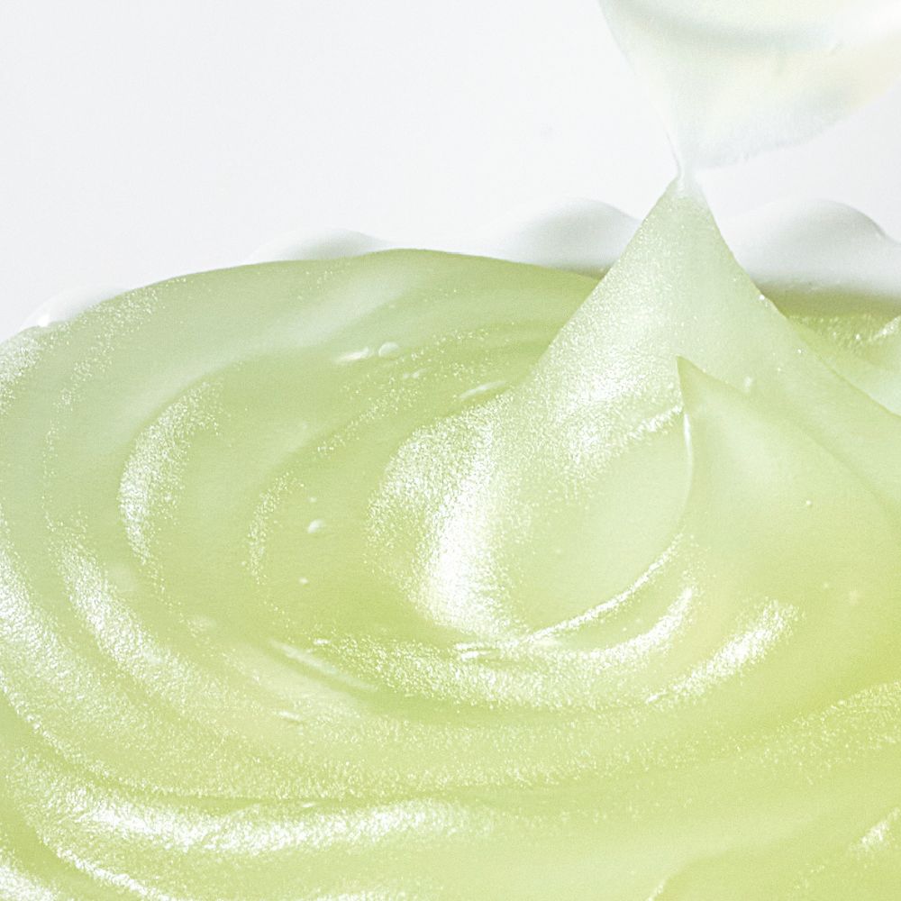 Frudia Green Grape Pore Control Face Moisturizer in a green jar, showing creamy texture and fresh green grape ingredients.