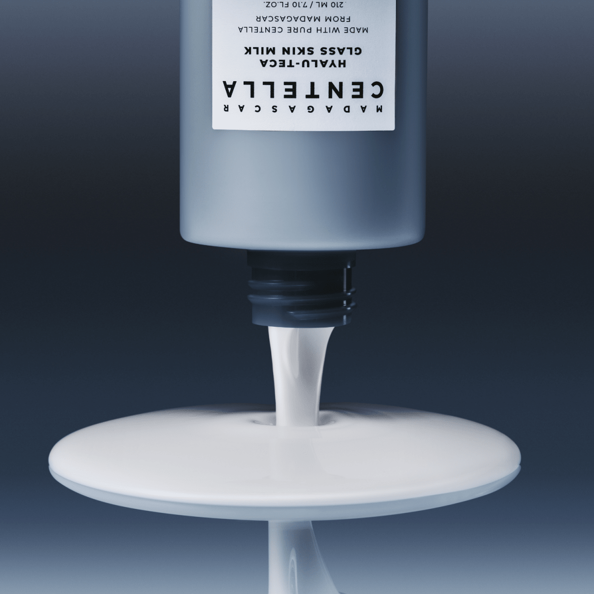 SKIN1004 Madagascar Centella Hyalu-Teca Glass Skin Milk essence in a 210ml bottle with a clear, sleek design and label.