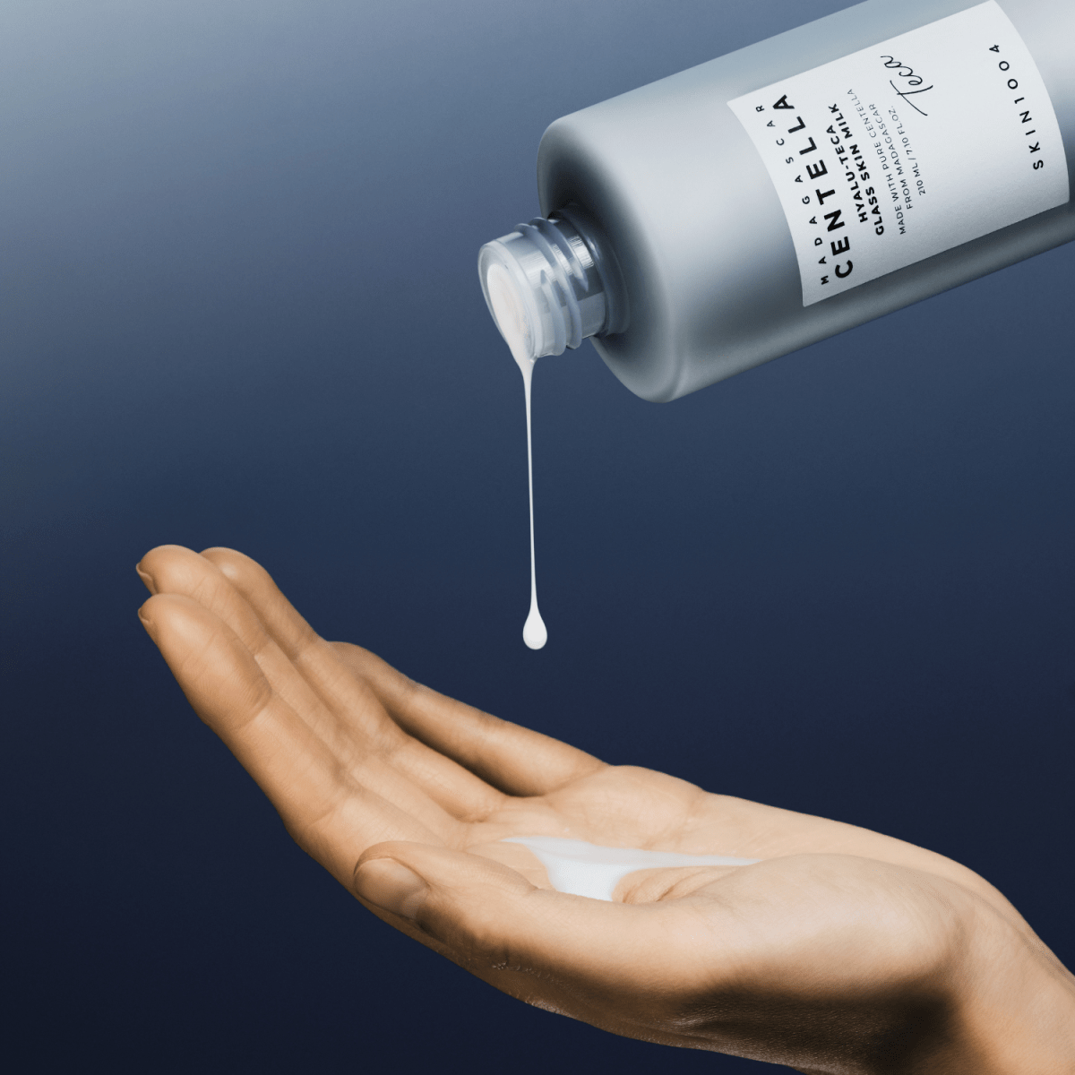 SKIN1004 Madagascar Centella Hyalu-Teca Glass Skin Milk essence in 210ml bottle, featuring clear packaging and product label.
