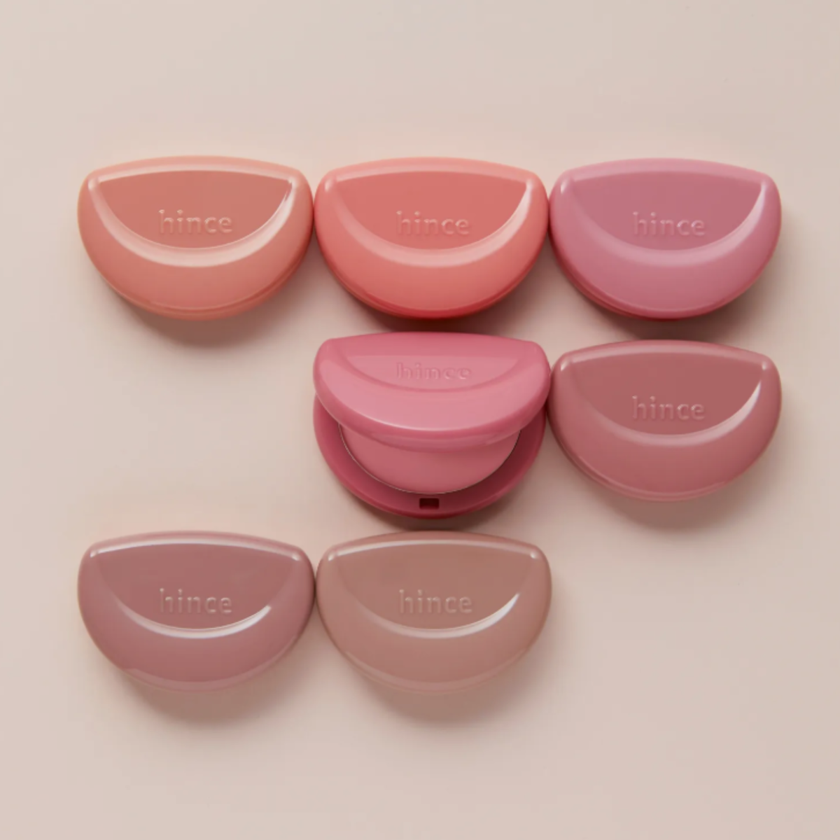Hince Half-Moon Cheek Cream To Powder Blush in a compact, showing the soft pink blush and sleek packaging.
