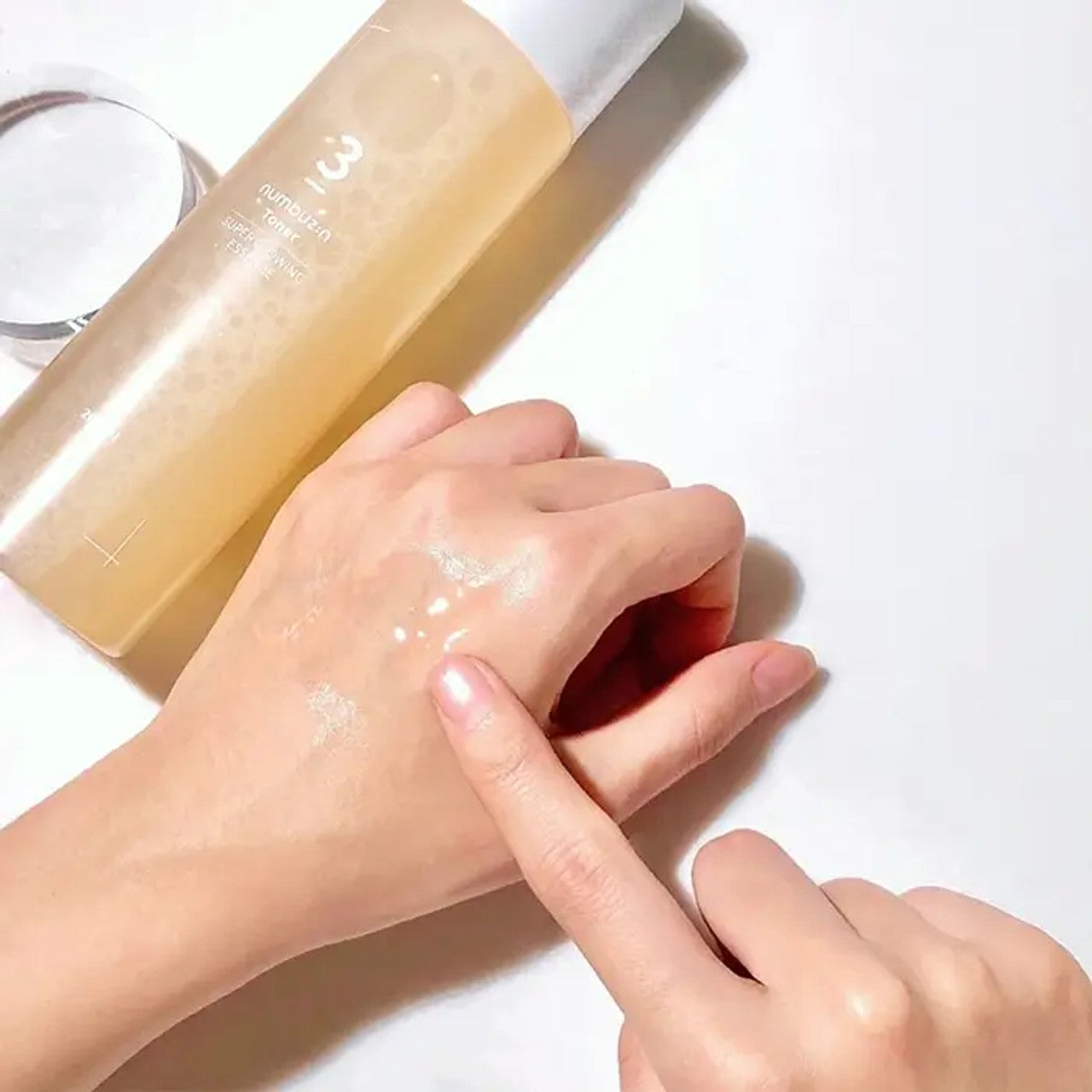 Numbuzin No.3 Super Glowing Essence Toner 200ml bottle with clear liquid and minimalist label, skincare product for radiant skin
