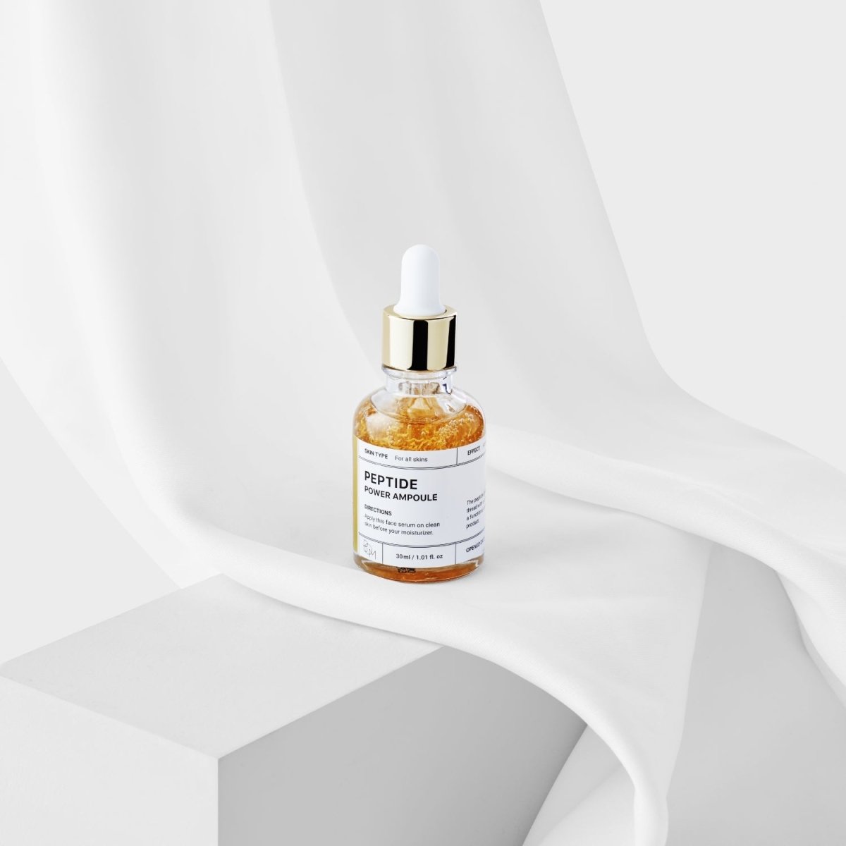 B.O.M Peptide Power Ampoule 30ml bottle showing clear liquid inside a dark glass ampoule for skincare treatment.