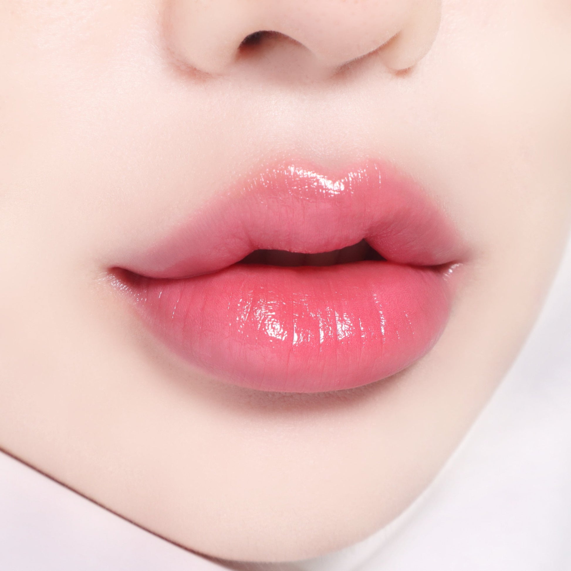 Banila Co B. By Banila Glow Veil Lipstick in pink shade, showcasing smooth, creamy lipstick on lips with a soft glow finish.