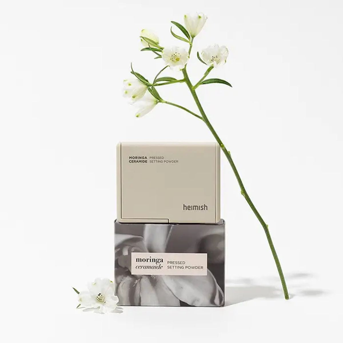Heimish Moringa Ceramide Pressed Setting Powder in 5g compact, with smooth pressed powder surface and brand logo visible.