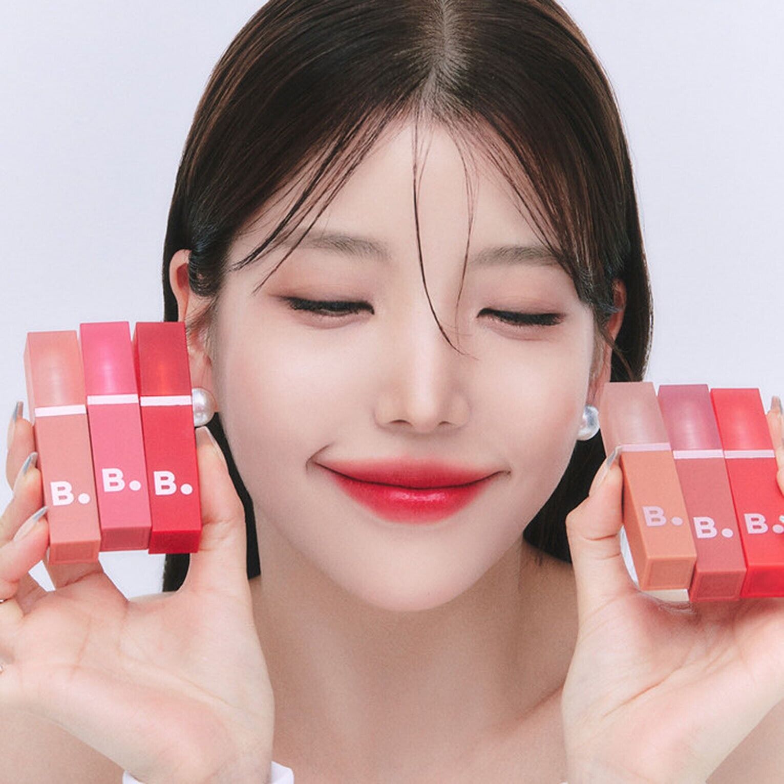 Banila Co B. By Banila Sheer Velvet Veil Lip Tint in a soft, natural shade, showing the sleek packaging and product applicator.