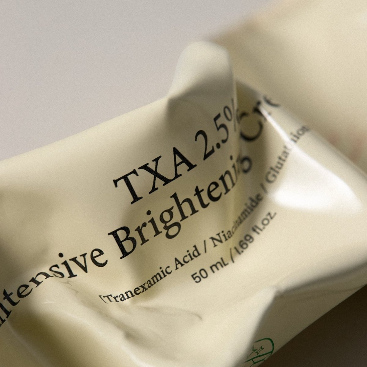 Axis-Y TXA 2.5% Intensive Brightening Cream in 50ml jar, a face moisturizer with brightening and hydrating properties.