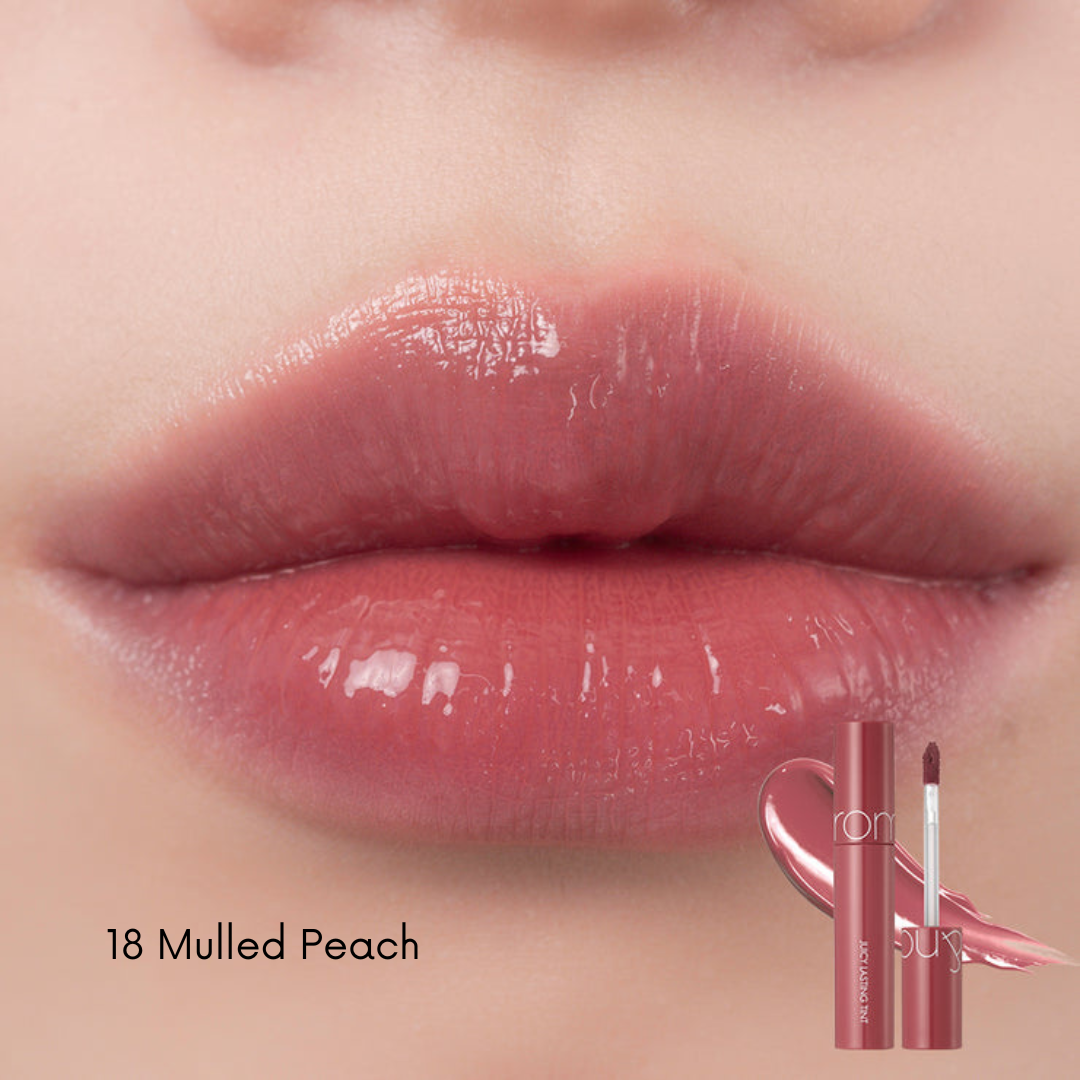 Rom&nd Juicy Lasting Tint lip tint in a vibrant shade, showing the sleek tube and applicator with the product label.