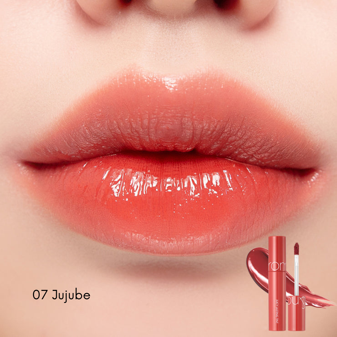 Rom&nd Juicy Lasting Tint lip tint in a sleek tube with the applicator visible, showcasing vibrant color for natural, long-lasting lips.