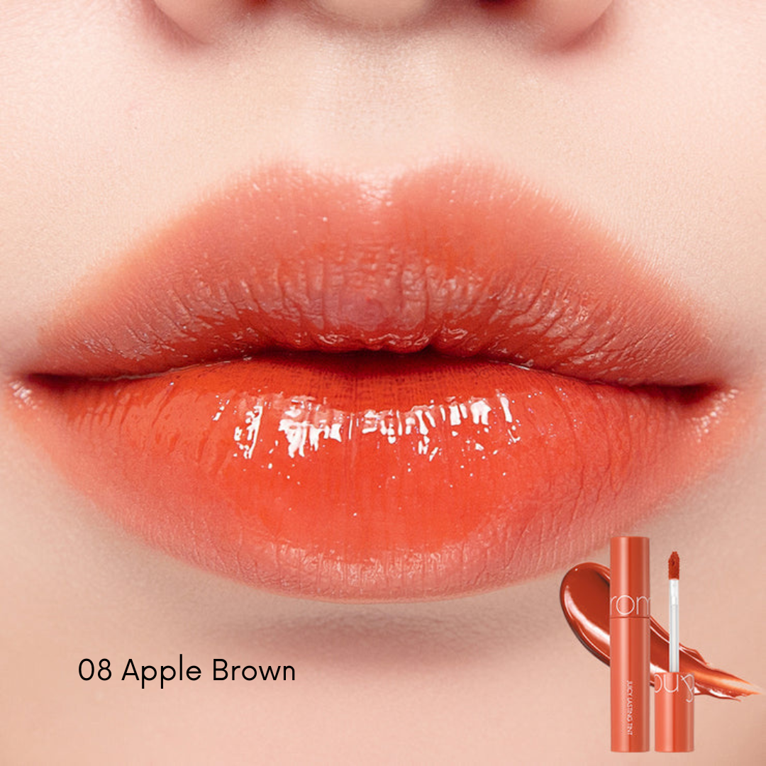 Rom&nd Juicy Lasting Lip Tint in vibrant red, showing the slim tube and applicator with the product's rich color on the tip.
